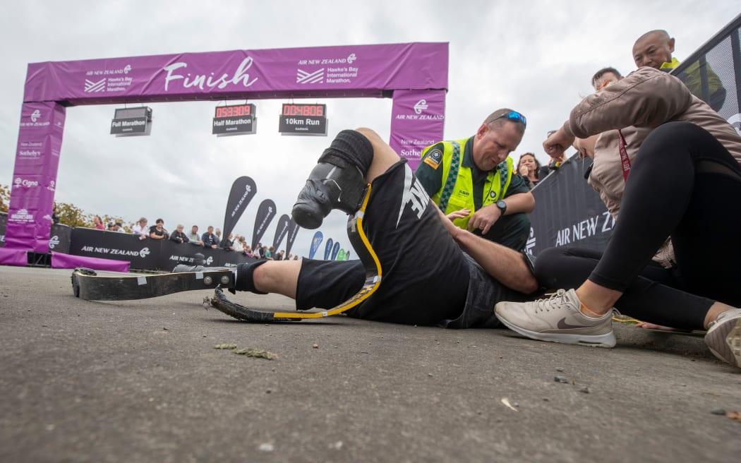 Liam Malone receiving medical attention after finishing Hawke's Bay marathon