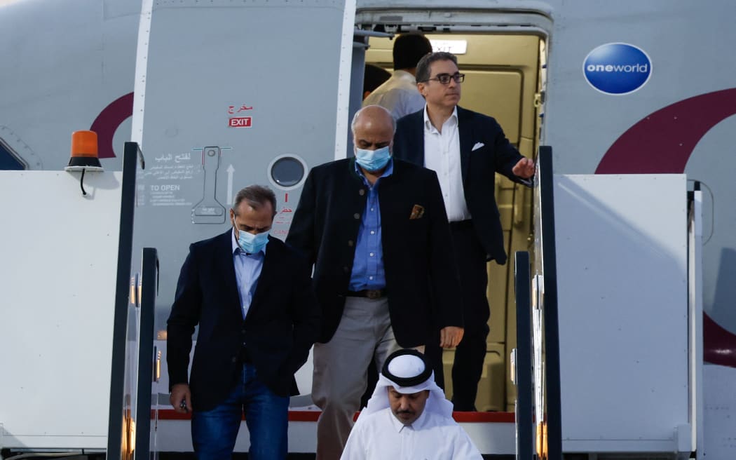 US citizens Siamak Namazim right, (at back), Emad Sharqi, left, and Morad Tahbaz, centre, disembark from a Qatari jet upon their arrival at the Doha International Airport in Doha on18  September, 2023.