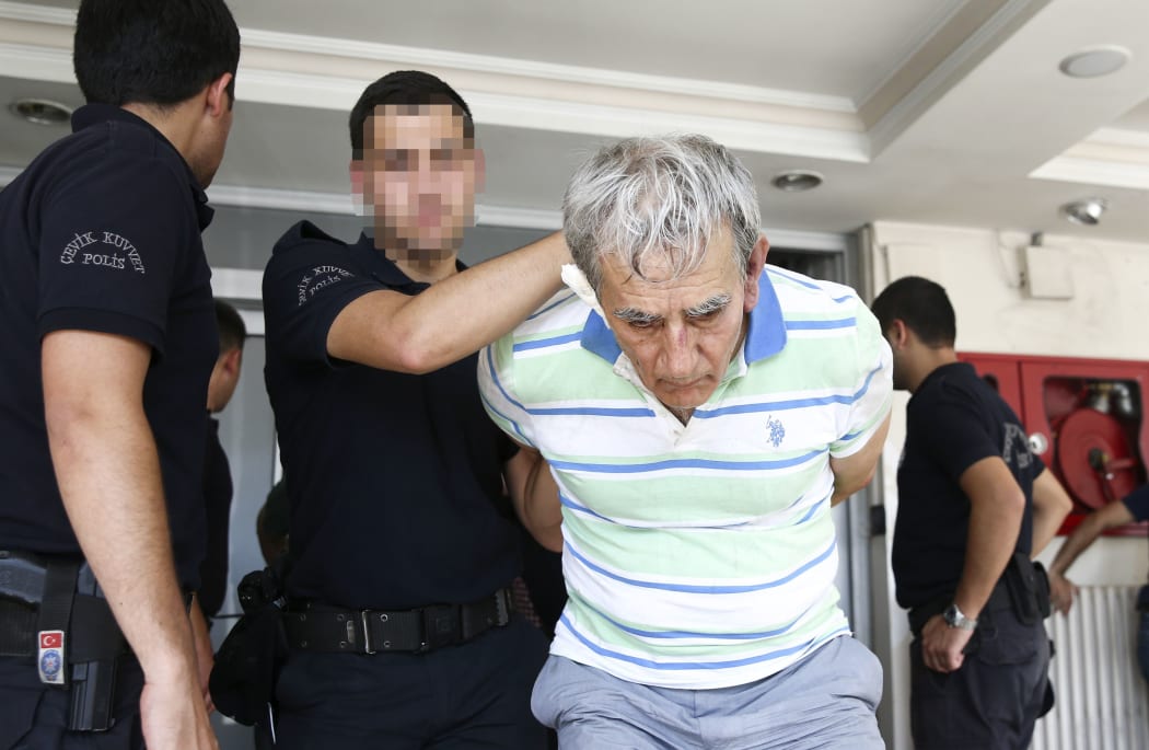 Turkish former Air Force Commander Gen. Akin Ozturk (R) is seen under custody at Ankara Police Headquarters Counter-Terrorism Branch following the failed Parallel State/Gulenist Terrorist Organization's military coup attempt, in Ankara, Turkey