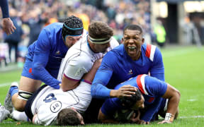France's Yoram Moefana celebrates scoring a try with Cameron Woki in a Six Nations Test against Scotland.