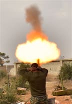 A soldier of pro-government militia fires mortar to rebel-held areas in Aleppo, Syria, on Dec. 11, 2016.
