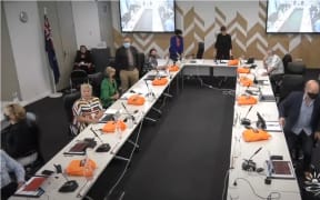Gisborne Mayor Rehette Stoltz adjourns the council meeting and five councillors, right, make for the door. Other councillors turned away, while some continued to watch.
