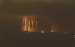 A picture taken from northern Israel, along the border with southern Lebanon, on September 30, 2024 shows a fire following Israeli bombardment on an area of south Lebanon. The Israeli military said Tuesday troops have started "targeted ground raids" in villages of southern Lebanon. The incursions backed by airstrikes and artillery began "a few hours ago" and are targeting militant group Hezbollah "in villages close to the border" with Israel, a military statement said. (Photo by Jalaa MAREY / AFP)