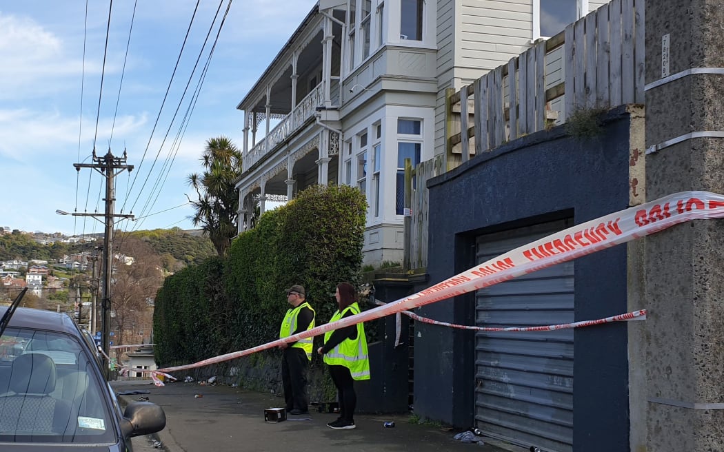 Security guards outside house where woman died in Dunedin - Dundas Street