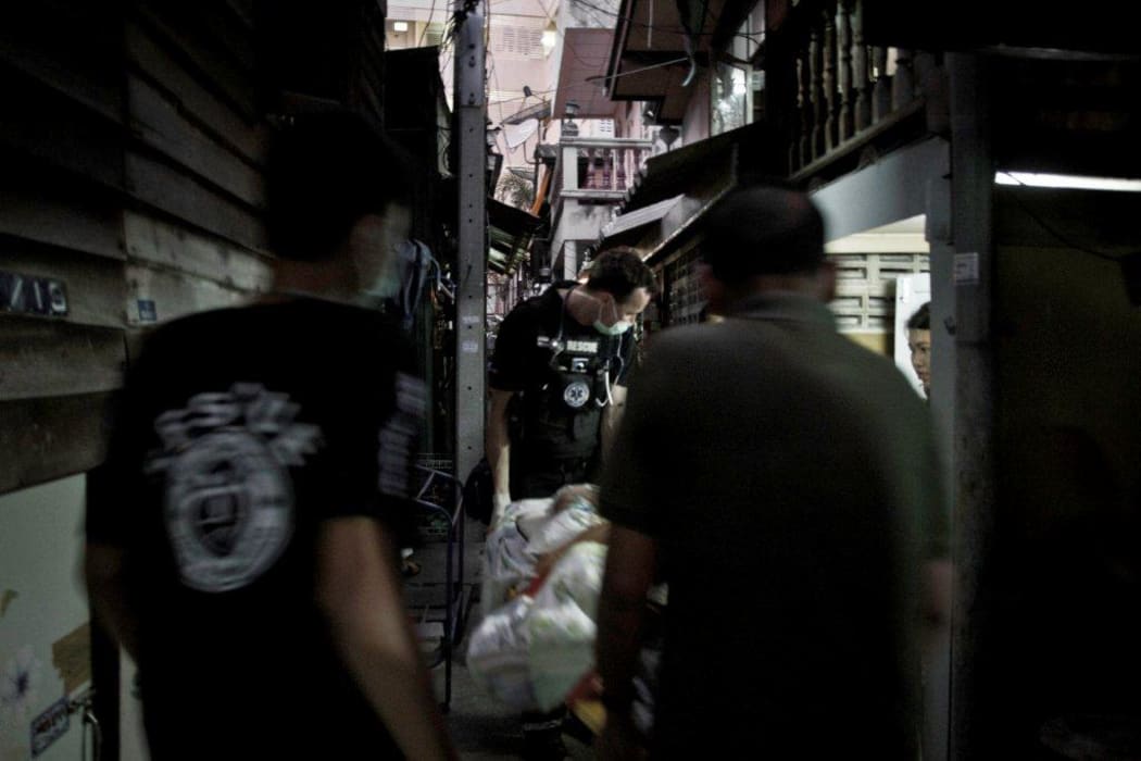 Transporting the patient through the squalid slums in Bangkok.