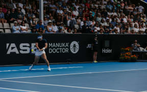 New Zealand tennis player Lulu Sun in front of a stand that will be demolished at Auckland Arena