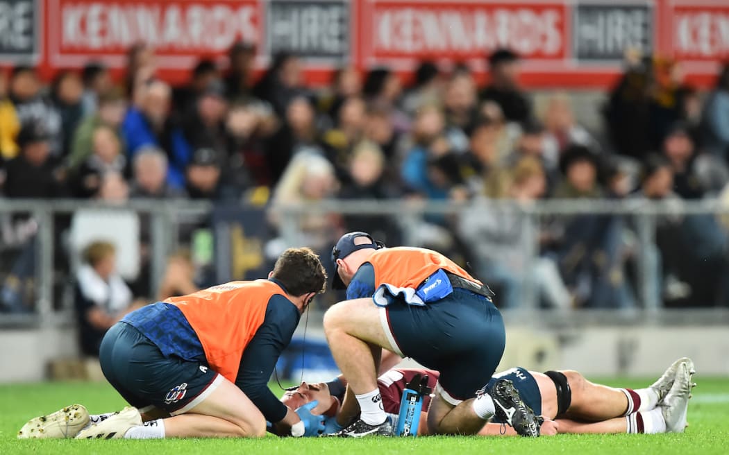 Connor Vest is treated after being injured in the Highlanders v Reds Super Rugby Pacific match at Forsyth Barr Stadium, Dunedin.