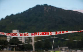 Emergency services cordon tape at Mount Maunganui beach after the January 22 landslide. Photo / Michael Craig