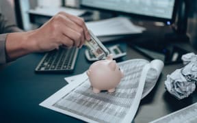 Investors hand putting money into piggy bank. Business saving money and financial concept.