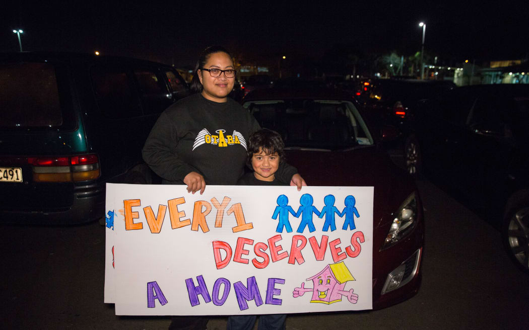 Lea Togia and her son at #Parkupforhomes in Mangere holding a banner which reads 'Everyone deserves a home'. 16 June 2016.