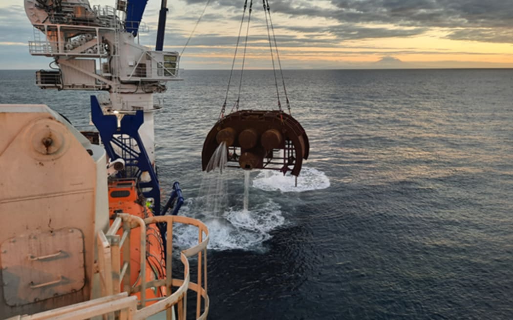 Mid water arches being hauled onto Sapura constructor on Tui Oil Field.