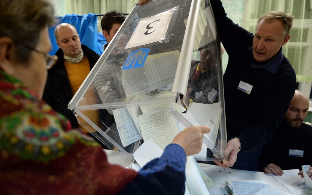Members of a local electoral commission count ballots at a polling station in Kiev.