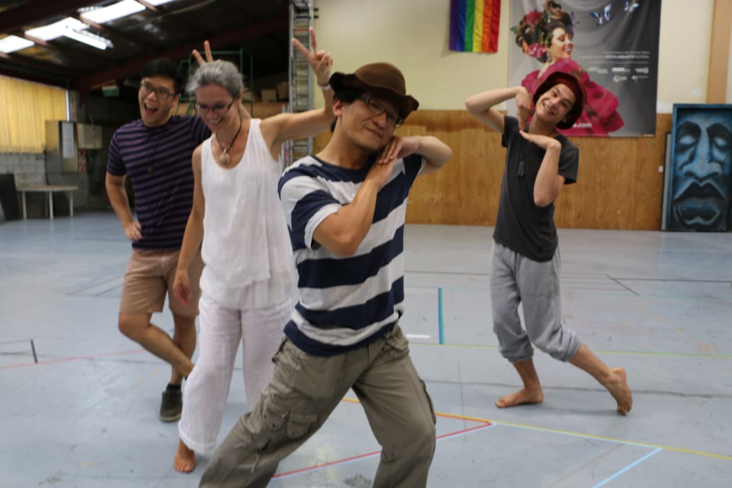 Rehearsing the  'Gong Hei' song, Director Sara Brodie choreographs Clinton Fung Yik, David Hwang and William King (chorus of Chinese miners).
