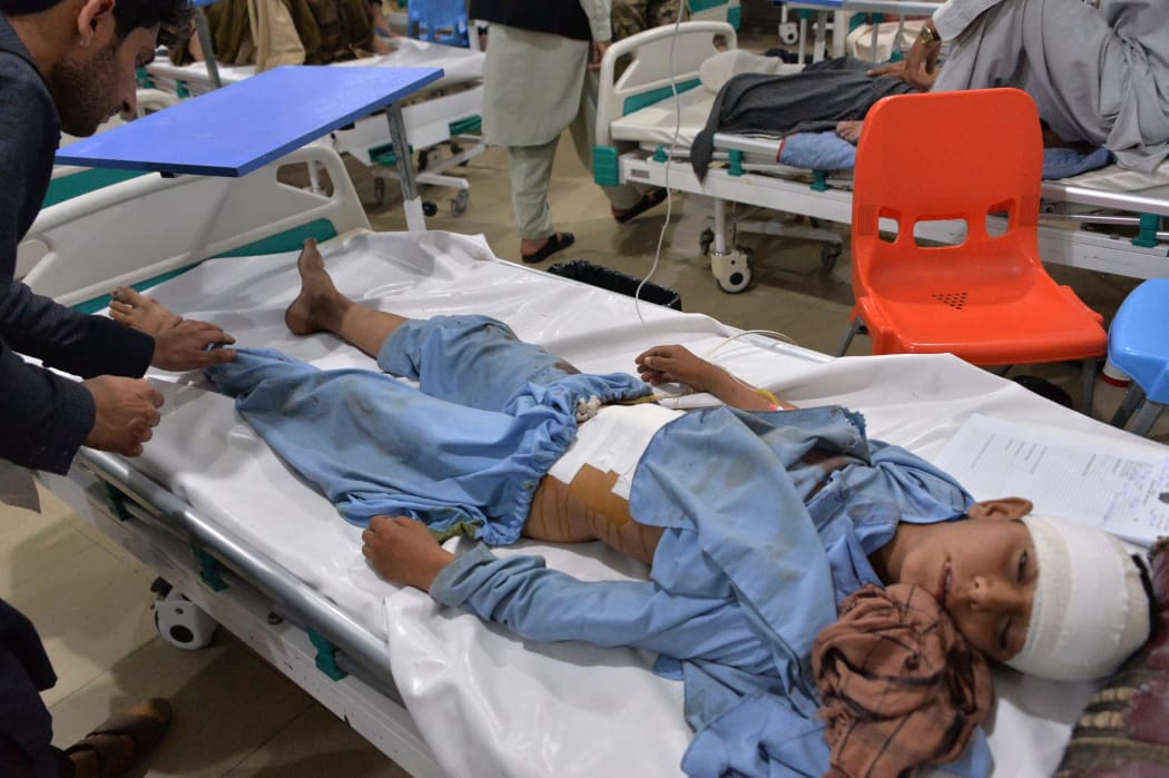 A young Afghan patient receives medical treatment at a hospital following a series of blasts in Jalalabad on May 13, 2019.