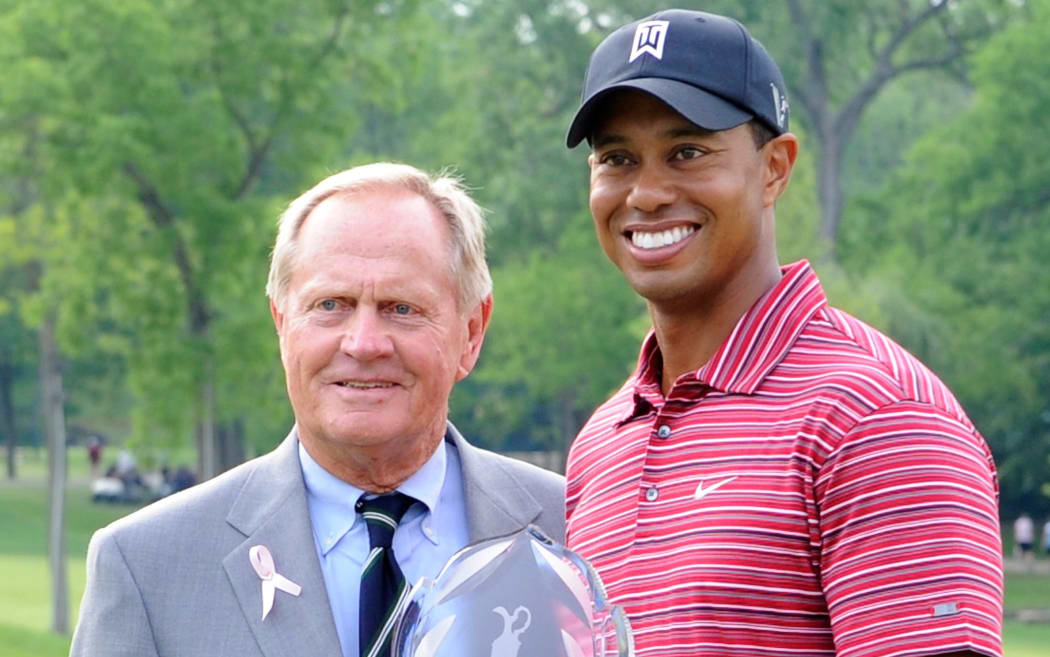 Tiger Woods celebrates a tournament victory alongside fellow golf great Jack Nicklaus.