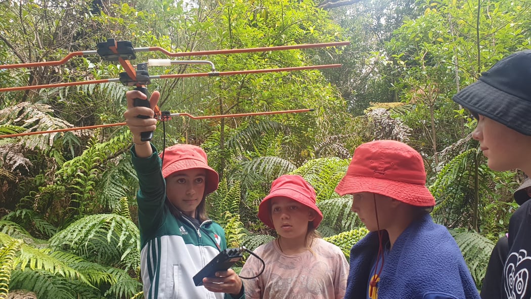 Evelyn Colegate and class mates from Oakura School search for signals to track kiwi's movements