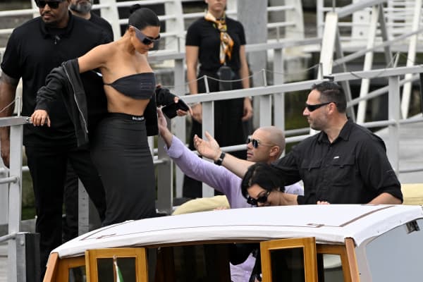 US reality TV personalities Kim Kardashian and Kris Jenner board a taxi boat at Venice Marco Polo airport ahead of Jeff Bezos' wedding on June 26, 2025. Celebrities in superyachts sail into Venice this week for the three-day wedding party of Amazon tycoon Jeff Bezos and Lauren Sanchez, despite irate locals who say the UNESCO city is no billionaire's playground. The tech magnate and journalist have reportedly invited about 200 guests to their multi-million dollar nuptials in the Italian city, which are expected to kick off on June 26 and end Saturday with a ceremony at a secret location. (Photo by ANDREA PATTARO / AFP)