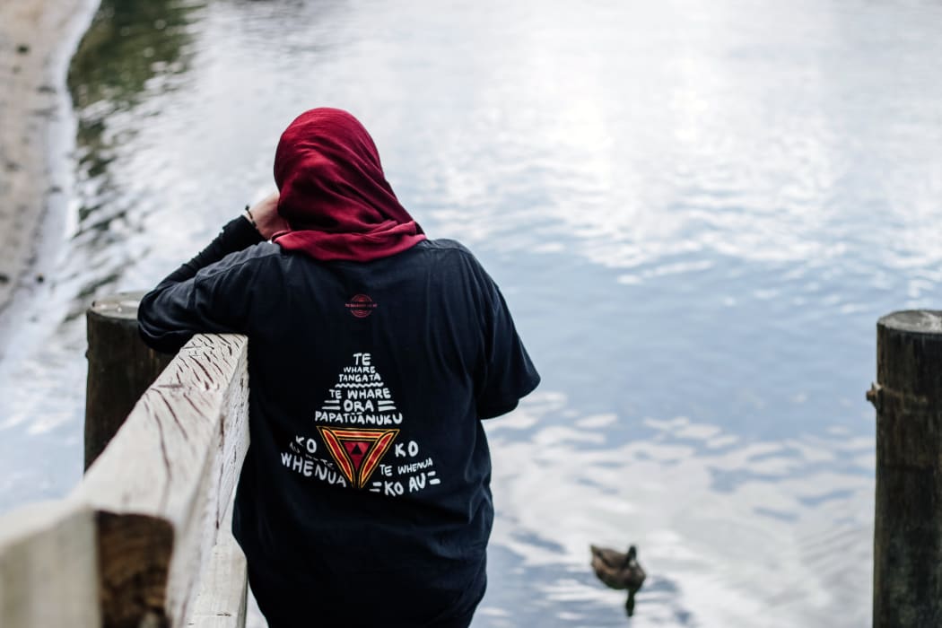 Shaymaa wearing her TribalRoots tee shirt on the riverside of the Waikato.