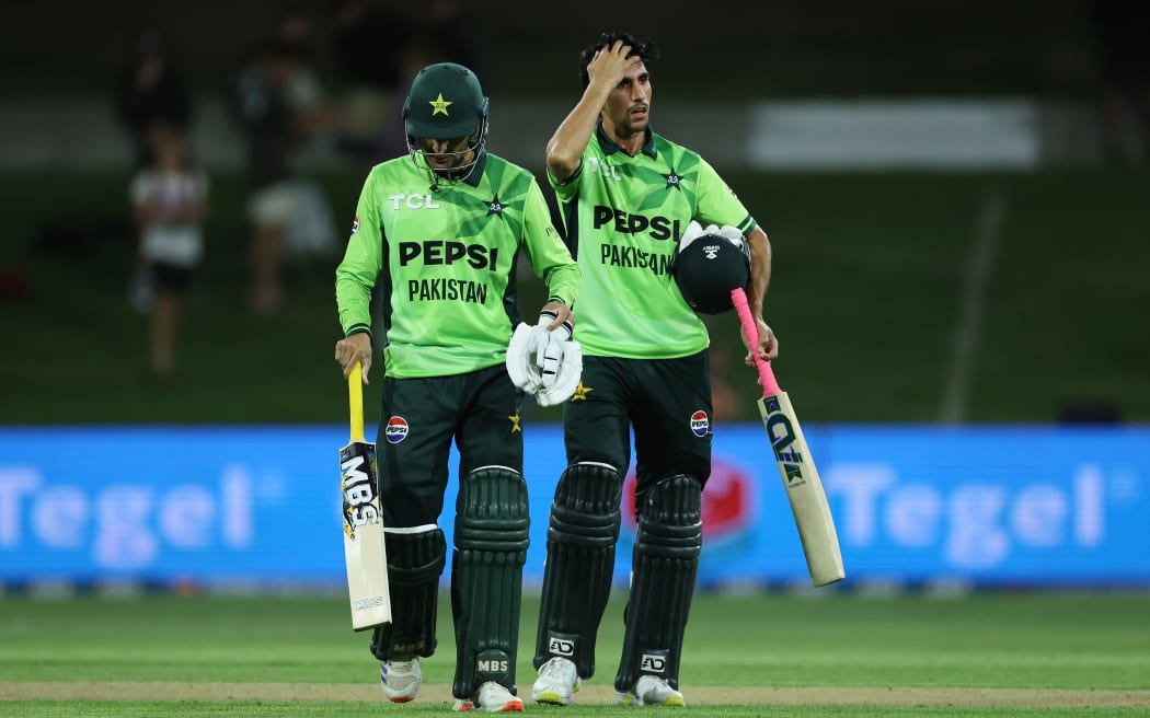 Pakistan's Akif Javed (R) with team mate Sufiyan Muqeem walk from the field after losing the third ODI against New Zealand at Bay Oval.