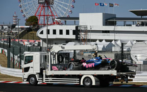 A truck transports the car of Alpine's Australian driver Jack Doohan after he crashed out of the second practice session of the Formula One Japanese Grand Prix at the Suzuka circuit.