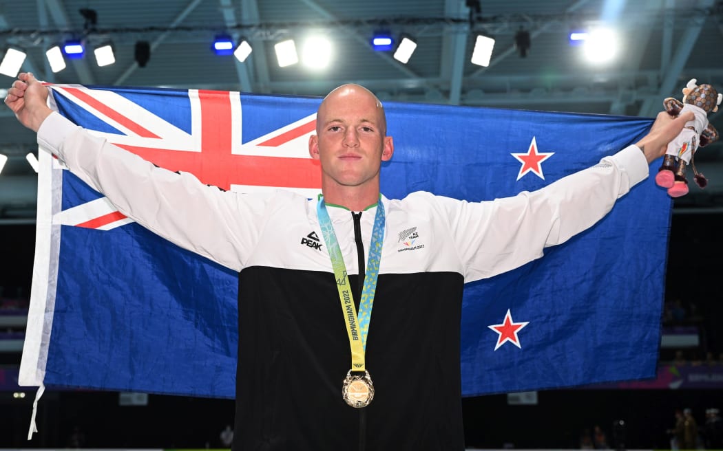 New Zealand's Andrew Jeffcoat poses with his gold medal after winning the Men’s 50m Backstroke Final in Birmingham.