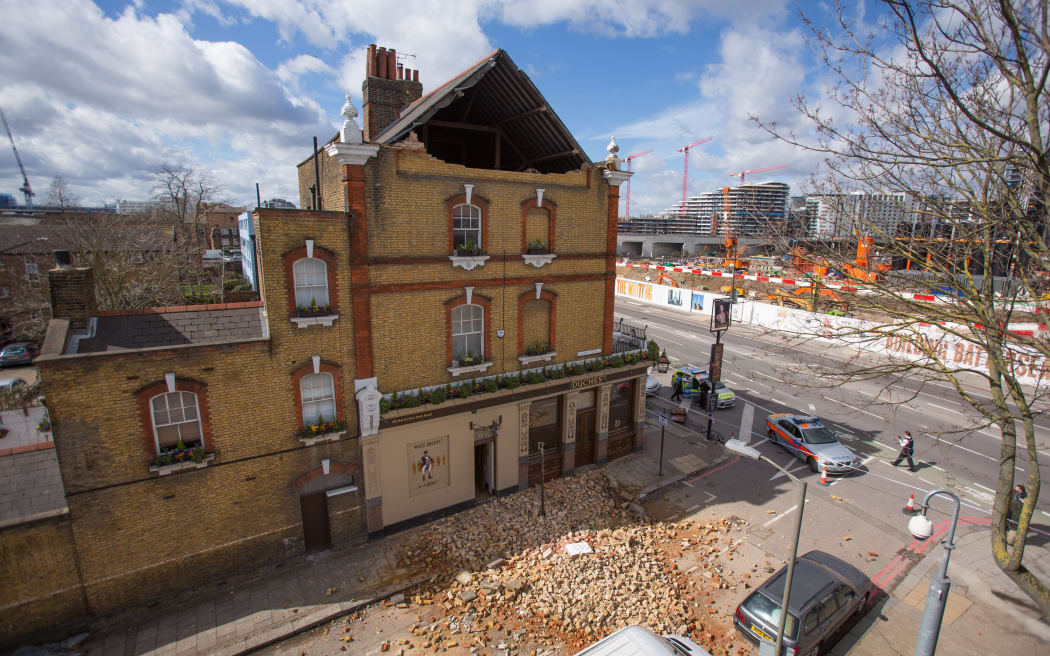 Masonry lies in a pile in the road outside The Duchess public house after Storm Katie's high winds brought down part of the building's roof support