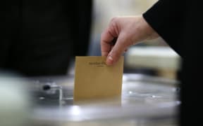 A voter casts a ballot at a polling station in Pantin, northeast of Paris.