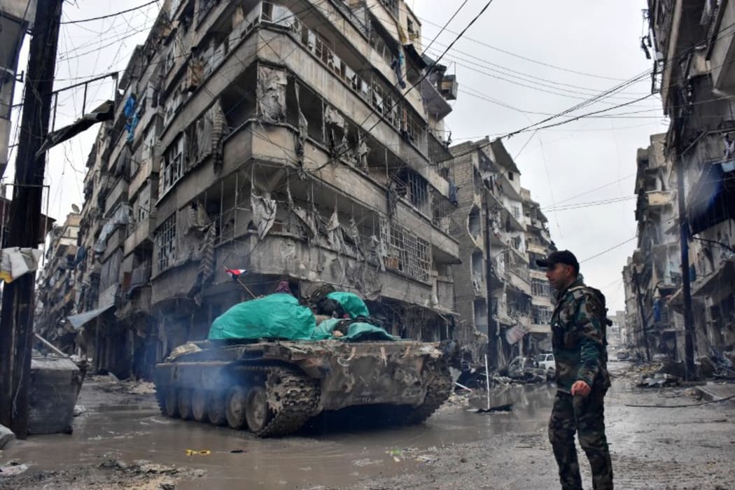 Syrian pro-government forces advance in the Jisr al-Haj neighbourhood during the ongoing military operation to retake remaining rebel-held areas in the northern embattled city of Aleppo on December 14, 2016.