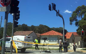 Police block the main road leading to the Banksia Public School after the crash that caused the deaths of two boys.