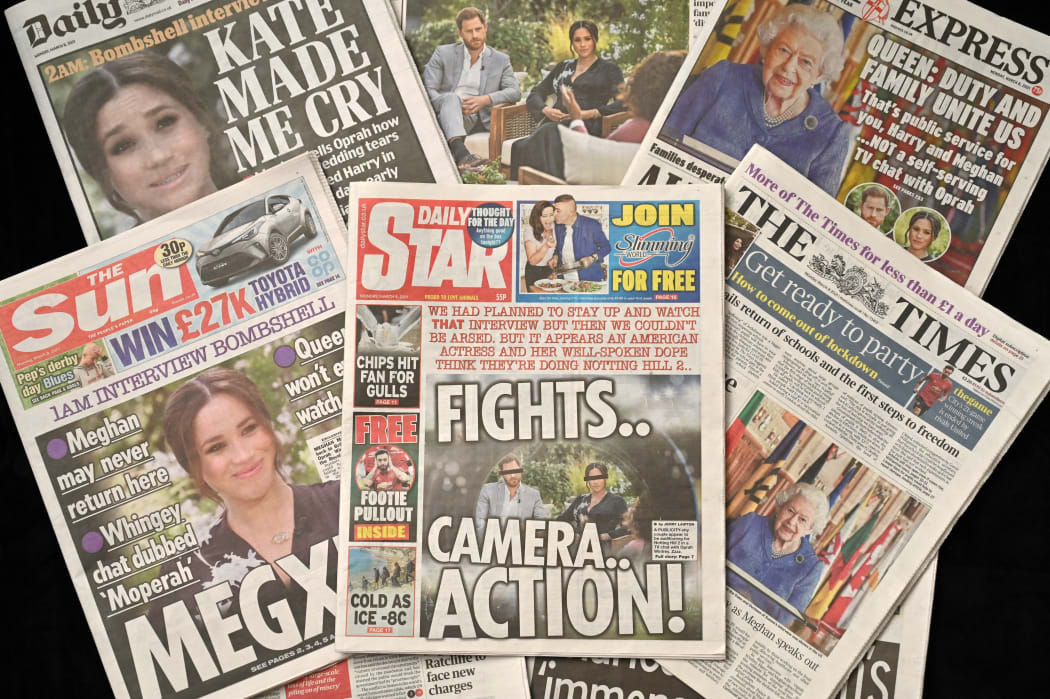 An arrangement of UK daily newspapers photographed as an illustration, shows front page headlines reporting on the story of the interview given by Meghan, Duchess of Sussex, wife of Britain's Prince Harry, Duke of Sussex, to Oprah Winfrey, which aired on US broadcaster CBS.