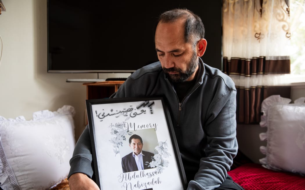 John Nabizadah with a picture of his father