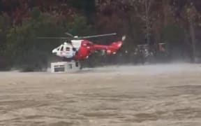 Nelson Marlborough Rescue Helicopter rescues a man after his car was submerged and his caravan partially submerged by the rising Motueka River