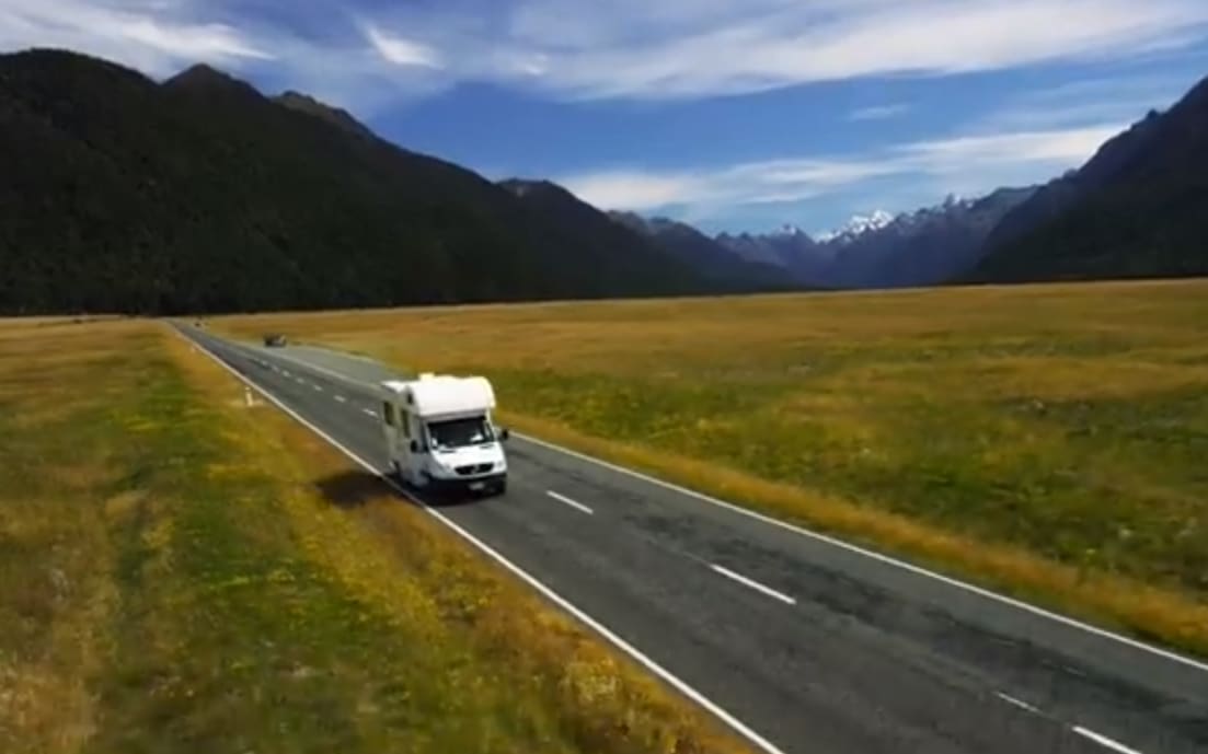 A camper van is seen driving on the wrong side of the road in a Tourism New Zealand video.