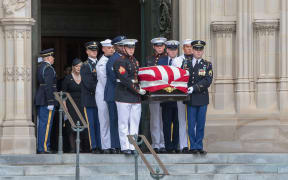 Megan McCain looks on as a Military Honor Guard carrying the casket of late Senator John McCain, Republican of Arizona, exits the National Cathedral after a funeral service at the National Cathedral in Washington, DC.