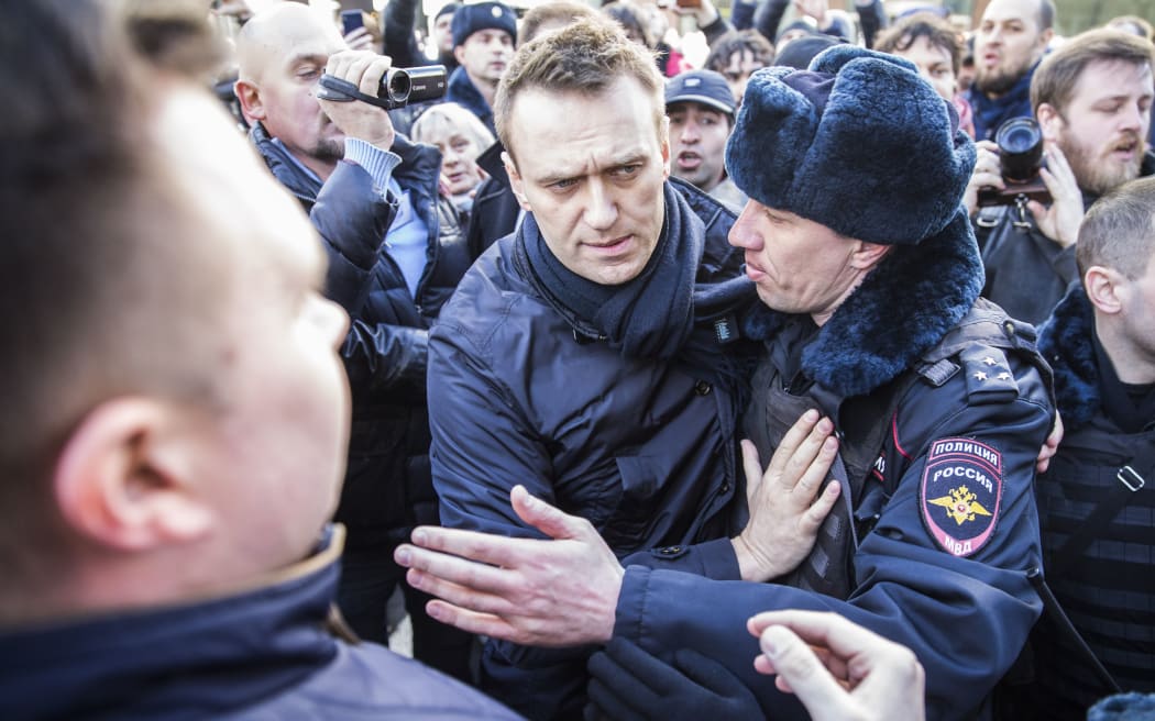 Police detain Kremlin critic Alexei Navalny during an unauthorised anti-corruption rally in central Moscow.