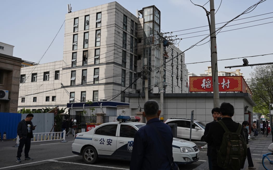 People gather outside the Changfeng Hospital, where a fire ripped through the building in Beijing, killing 21 people, state media reported. - An investigation was underway on April 19 after a fire ripped through a hospital in China's capital Beijing, killing 21 people, state media reported. (Photo by GREG BAKER / AFP)