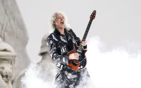 (FILES) In this file photo taken on June 4, 2022 British guitarist Brian May of Queen performs during the Platinum Party at Buckingham Palace as part of Queen Elizabeth II's platinum jubilee celebrations. - Brian May, guitarist of the rock band Queen, is one of 1,107 people who have been awarded this year in a list signed for the first time by King Charles III. These royal awards are given twice a year, on New Year's Day and on the King's official birthday, always celebrated in June, regardless of the monarch's actual date of birth (14 November 1948 for Charles III). (Photo by Alberto Pezzali / POOL / AFP)