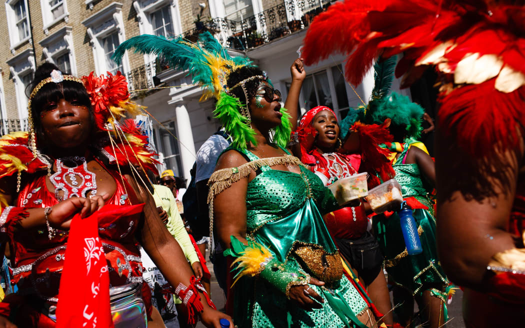 Paraders in feathered costumes make their way along Chepstow Road on the second and final day of the 2019 Notting Hill Carnival in London, England, on August 26, 2019.