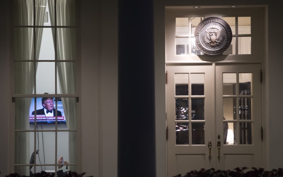 An image of US President Donald Trump appears on a television screen inside the West Wing of the White House.
