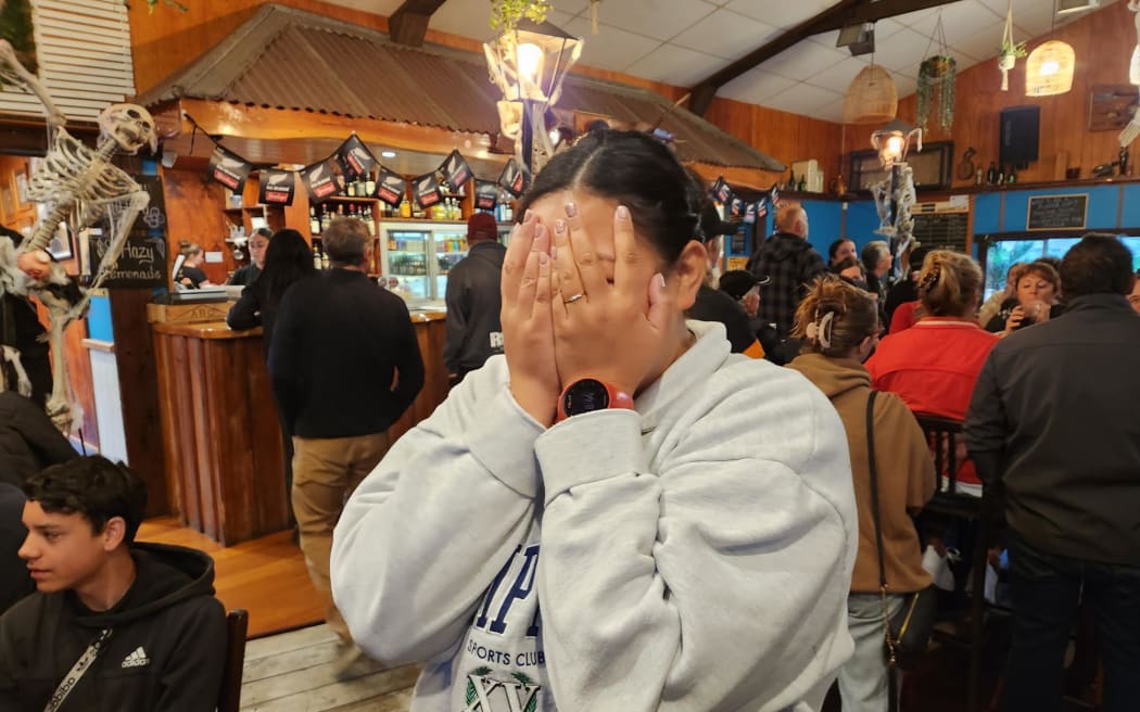 All Blacks fan Sophia Thomas of Te Tii reacts with disbelief at the Pioneer Tavern in Waipapa, as Sam Cane's yellow card is upgraded to red during the Rugby World Cup final between New Zealand and South Africa on 29 October, 2023.