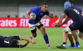 Samoa's Tusi Pisi takes on former Hurricanes teammate Blade Thompson.