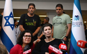 Yocheved Lifshitz, centre, speaks to the media alongside her daughter Sharone Lifschitz, left, outside Ichilov Hospital on October 24, 2023 in Tel Aviv, Israel after she was released by Hamas.