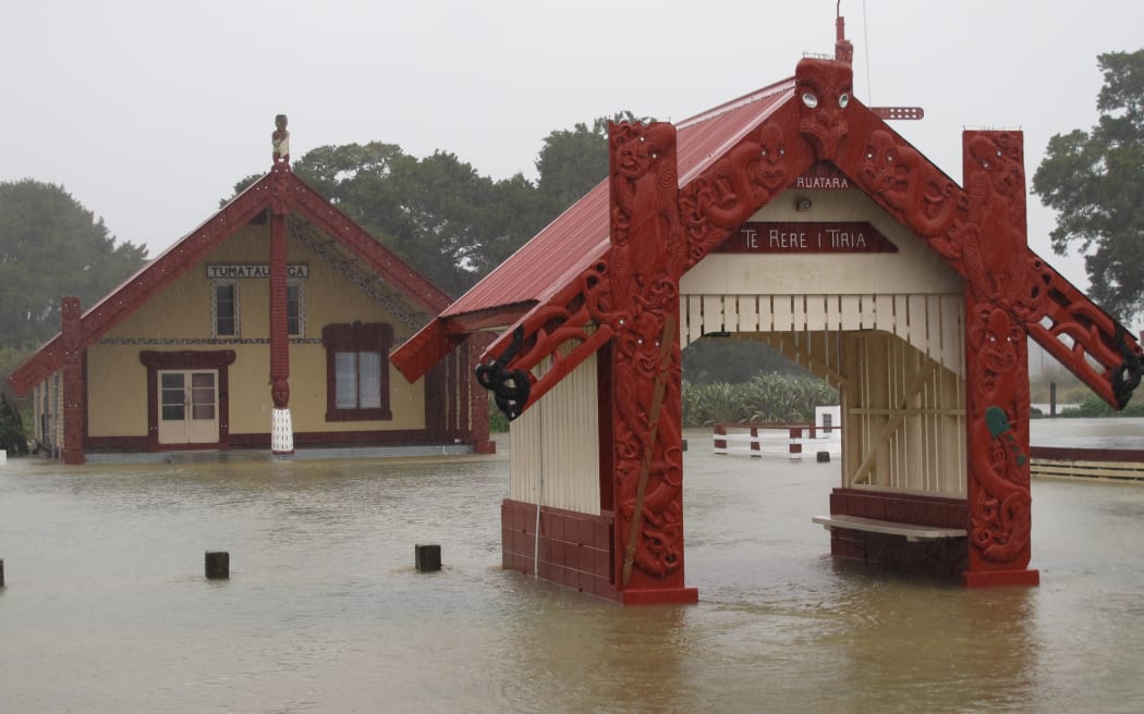 Floodwaters surge through the grounds of Ōtiria Marae, near Moerewa, during a flood in 2014.
