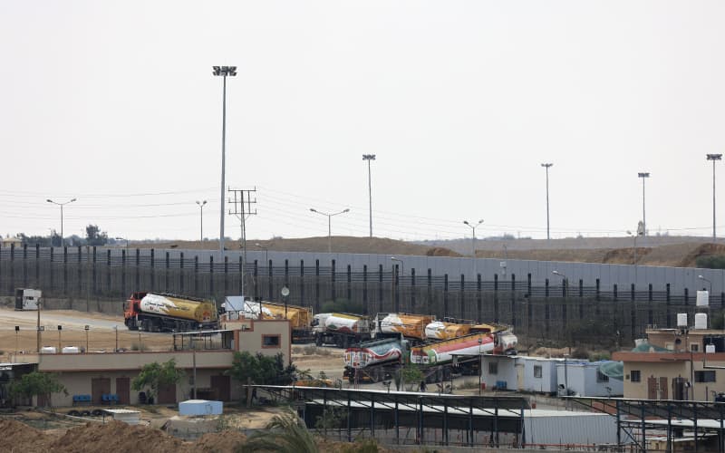 Trucks leave Gaza’s Rafah border crossing with Egypt during an Israeli airstrike on October 10, 2023. Gaza’s border crossing with Egypt, its only one that bypasses Israel, was hit by an Israeli air strike on October 10, 2023 for the second time in 24 hours, witnesses and a rights group said. Witnesses said the strike hit the no-man’s land between the Egyptian and Palestinian gates, damaging the hall on the Palestinian side.