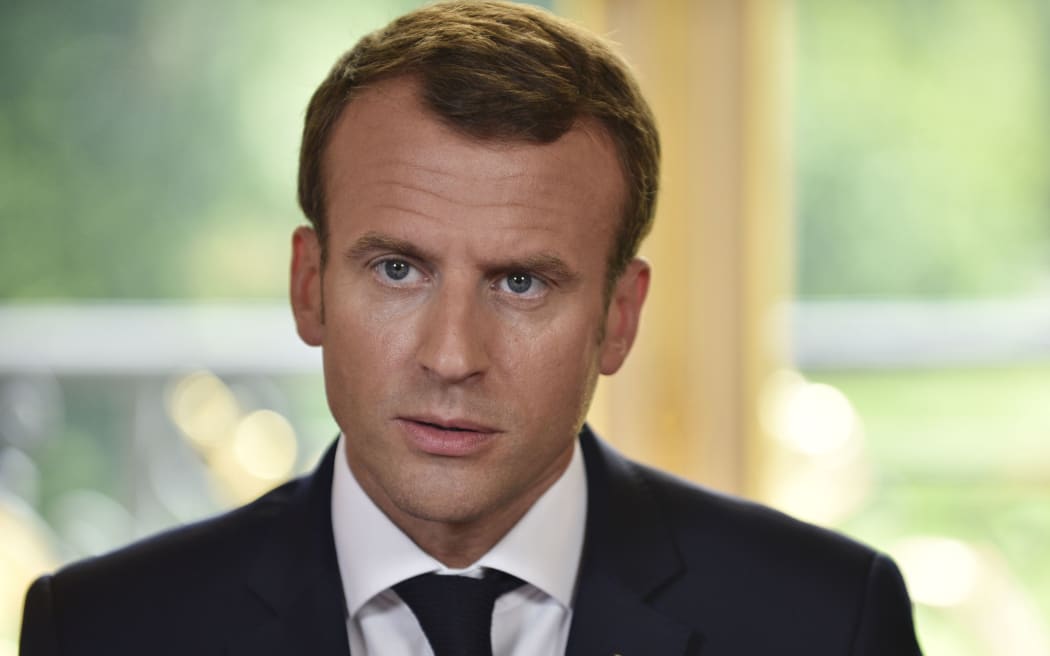 French President Emmanuel Macron speaks to journalists after he signed the controversial rail reform, at the Elysee Palace in Paris, on June 27, 2018. / AFP PHOTO / POOL / JULIEN DE ROSA