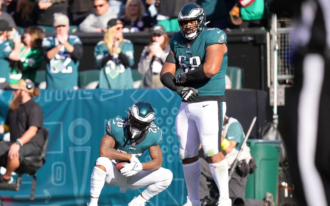 Miles Sanders #26 and Jordan Mailata #68 of the Philadelphia Eagles react after a touchdown from Sanders in the fourth quarter of a game against Pittsburgh Steelers at Lincoln Financial Field on 30 October 2022.