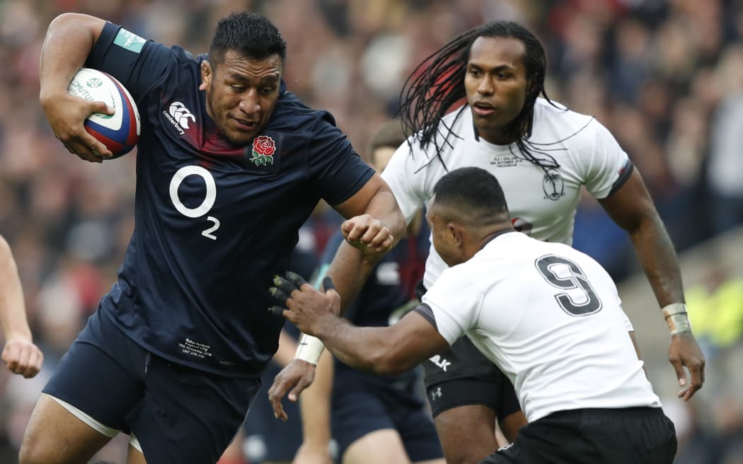 England's prop Mako Vunipola (L) vies with Fiji's scrum half Serupepeli Vularika.