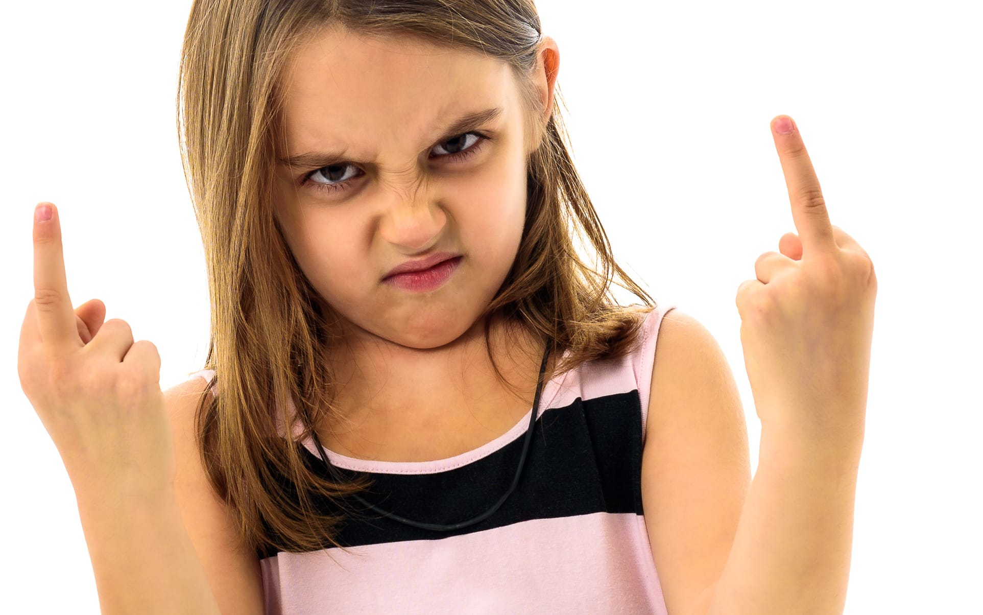 Little young girl is angry, mad, disobedient with bad behaviour. Children making the act of insubordination and disobedience, yelling, flipping off, showing the middle finger. Act of giving the finger.