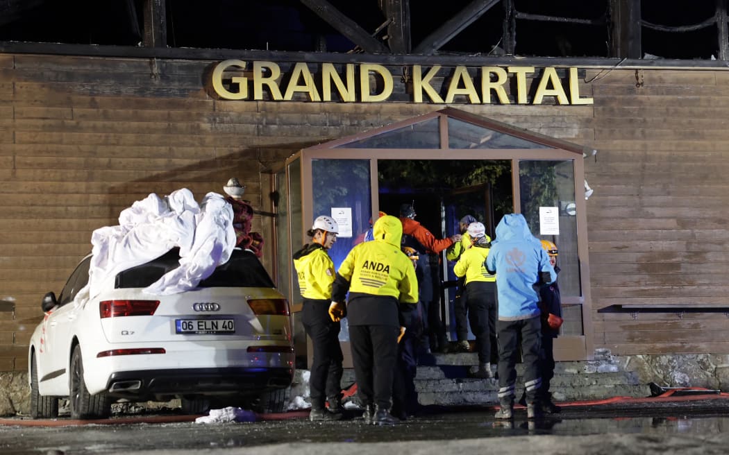 Search and rescue teams work at the site of a fire that broke out in a hotel in the Kartalkaya Ski Resort in Bolu, northwestern Turkey, on January 21, 2025. The number of dead from the fire that engulfed the hotel rose to 66, the interior minister said on January 21, 2025.