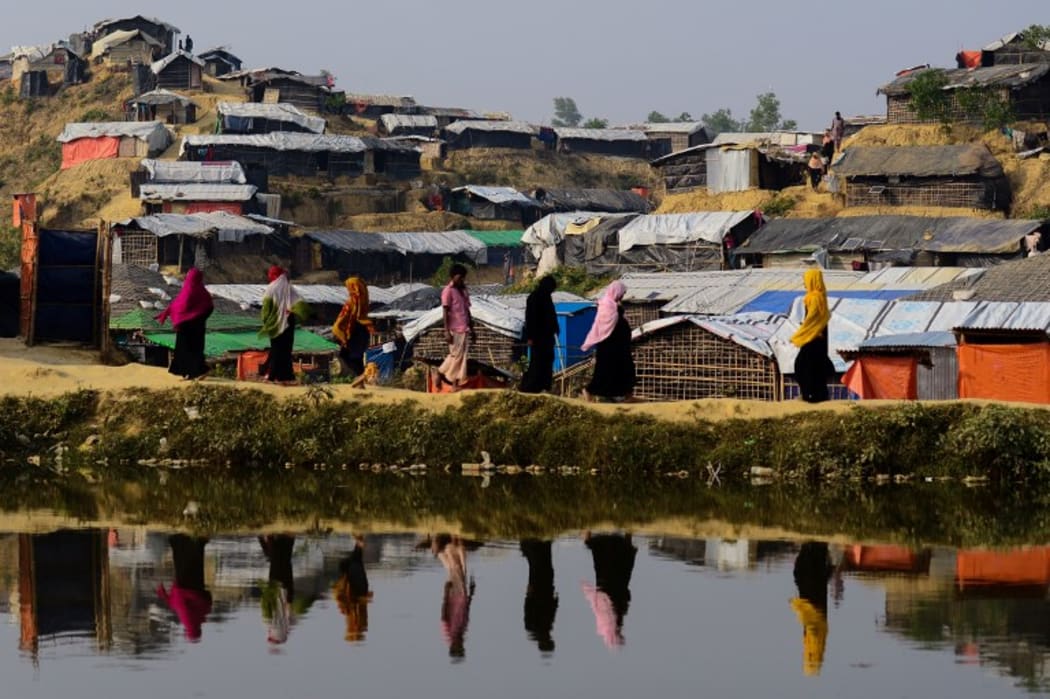Rohingya refugees walk back to their homes at Balukhali refugee camp in the Bangladeshi district of Ukhia.